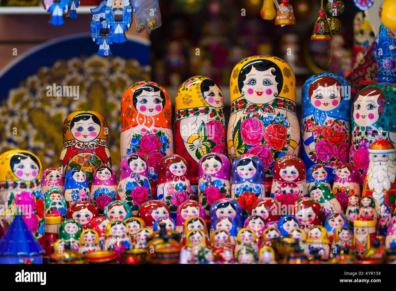 Several rows of colorful traditional Russian wooden toys matreshka on display for sale Stock Photo