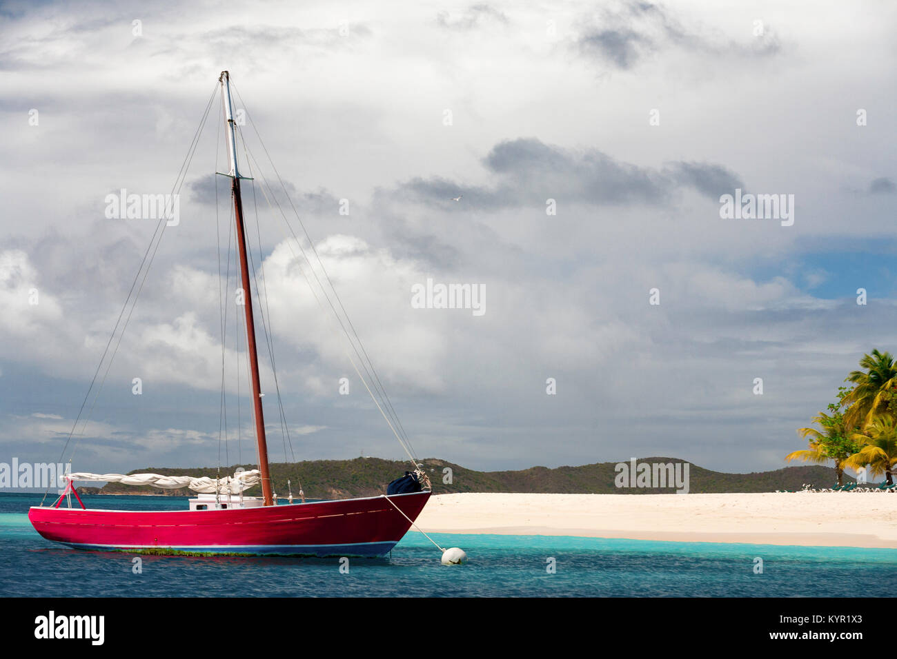 Red sailboat moored off of Palm Island, St. Vincent and the Grenadines, Lesser Antilles, Caribbean Stock Photo
