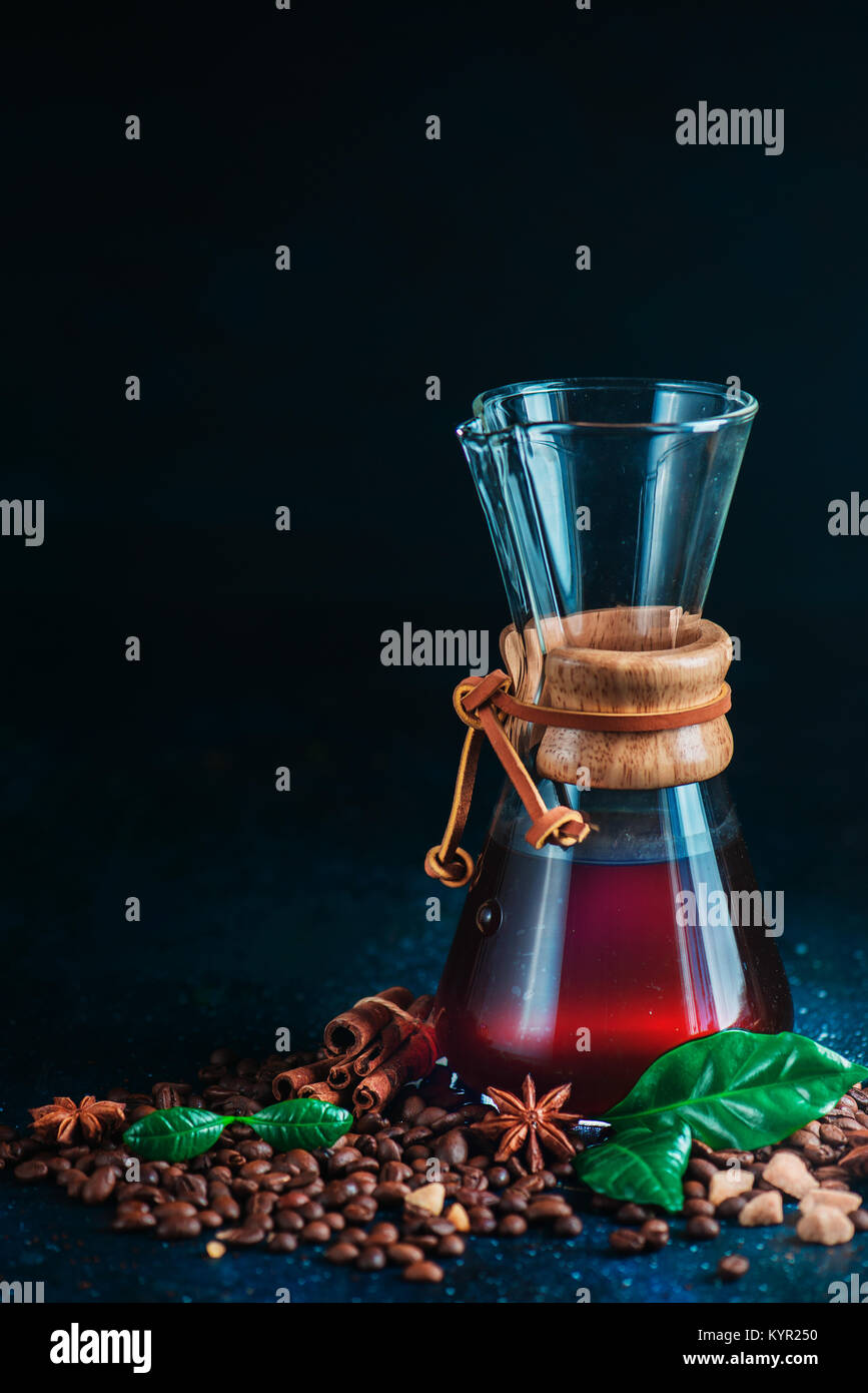 Hourglass coffee maker with coffee beans. Alternative coffee brewing method. Dark drink photography with copy space. Stock Photo