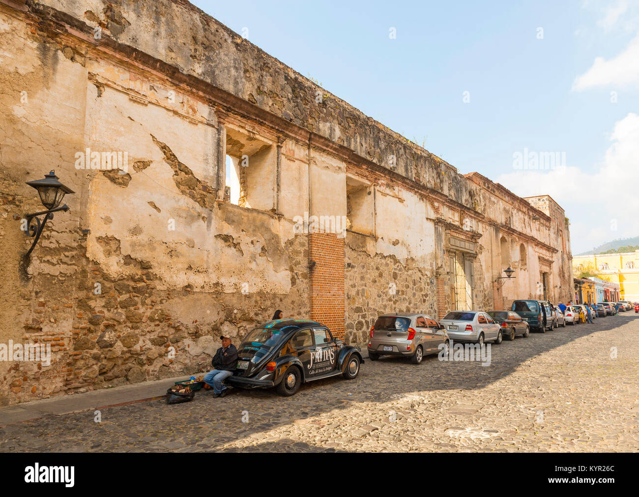 ANTIGUA, GUATEMALA - JANUARY 21: The historic cobblestoned 5th Avenue North in Antigua lined with cars and unidentified people and vendors on January  Stock Photo