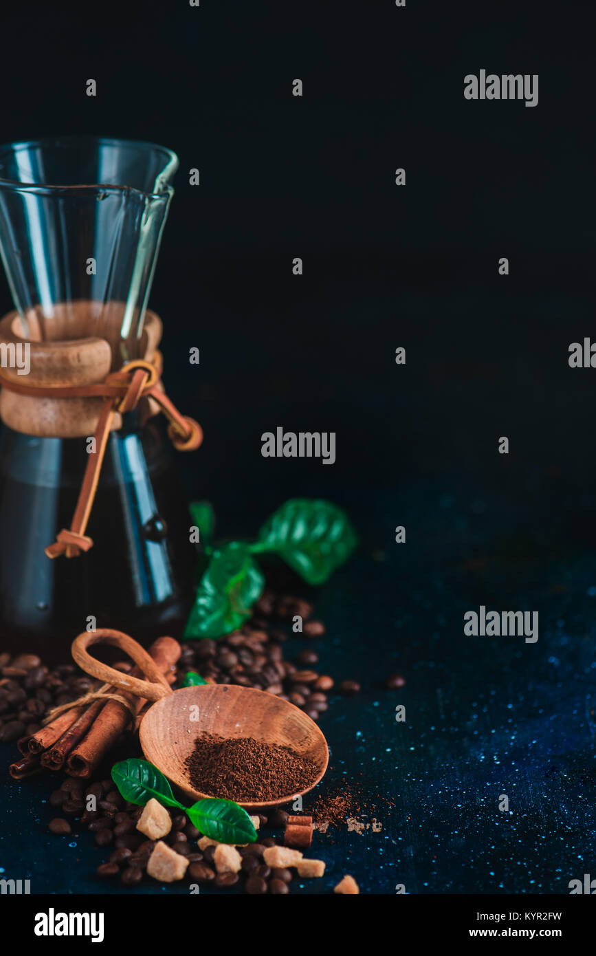 Hourglass coffee makerwith coffee beans and ground coffee. Alternative