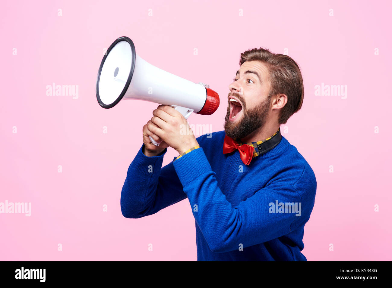Screaming man using a megaphone Stock Photo