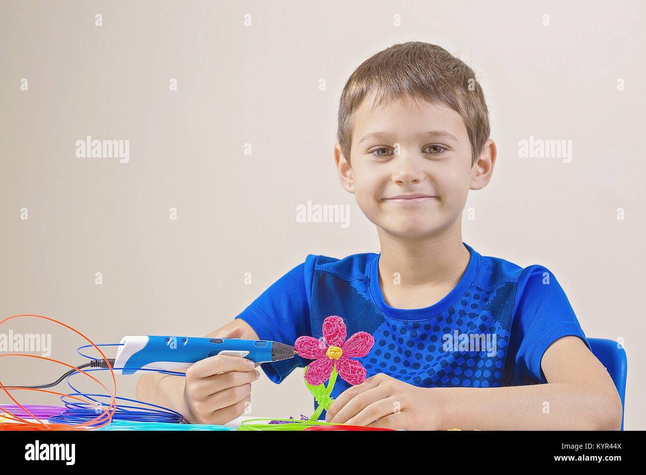Child creating with blue 3d printing pen Stock Photo - Alamy