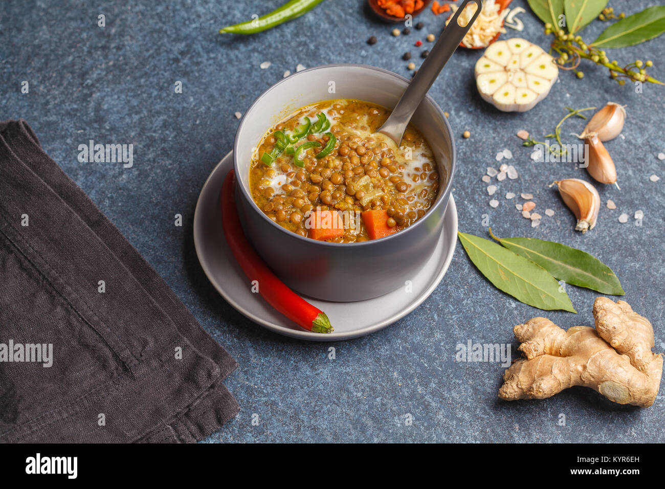 Indian vegetarian lentil soup, mung dal. Indian food spice concept. Dark background, top view