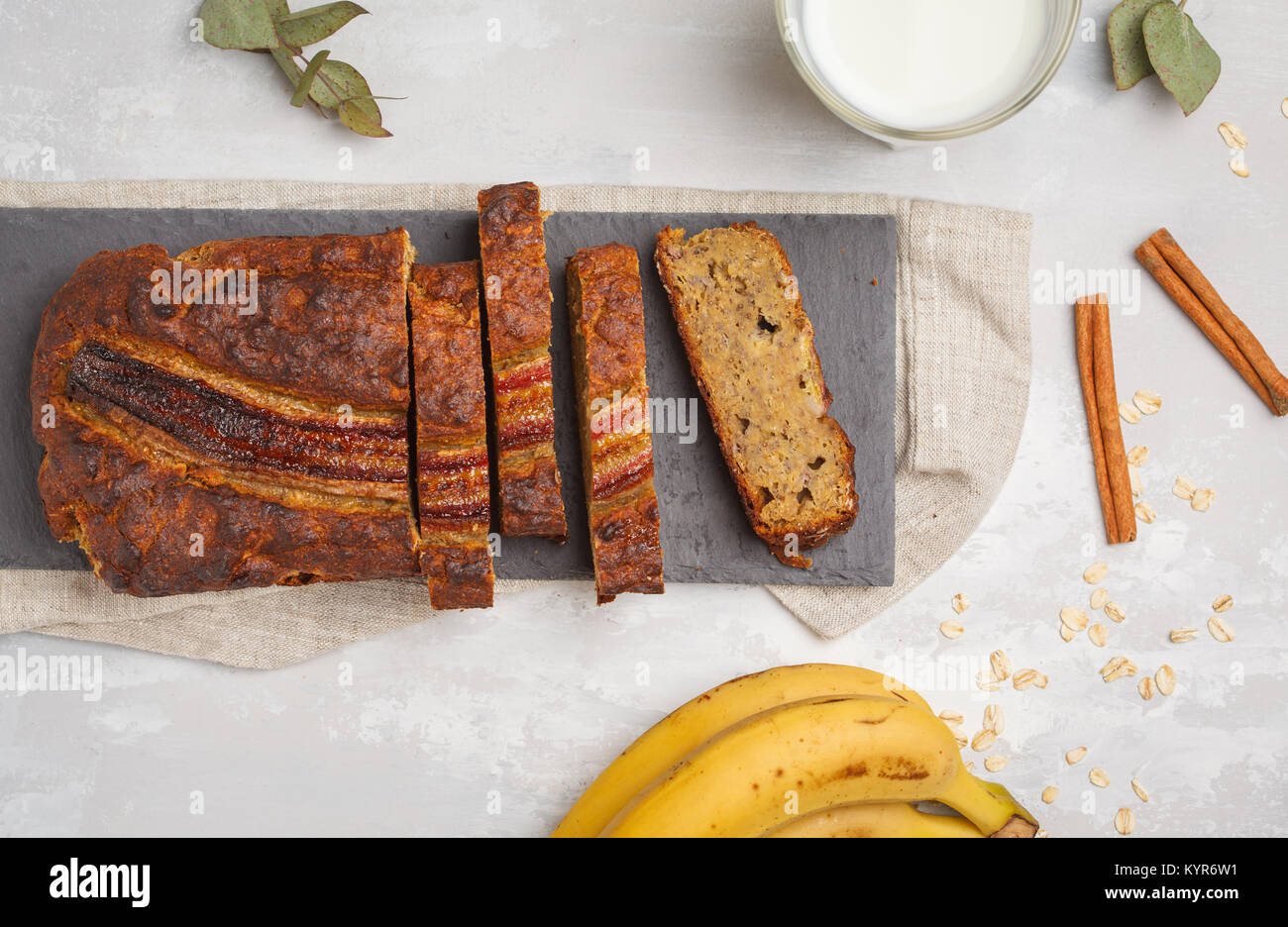 Sliced banana bread with cinnamon on a black slate.  Vegan Healthy Food Concept. Top view. Stock Photo