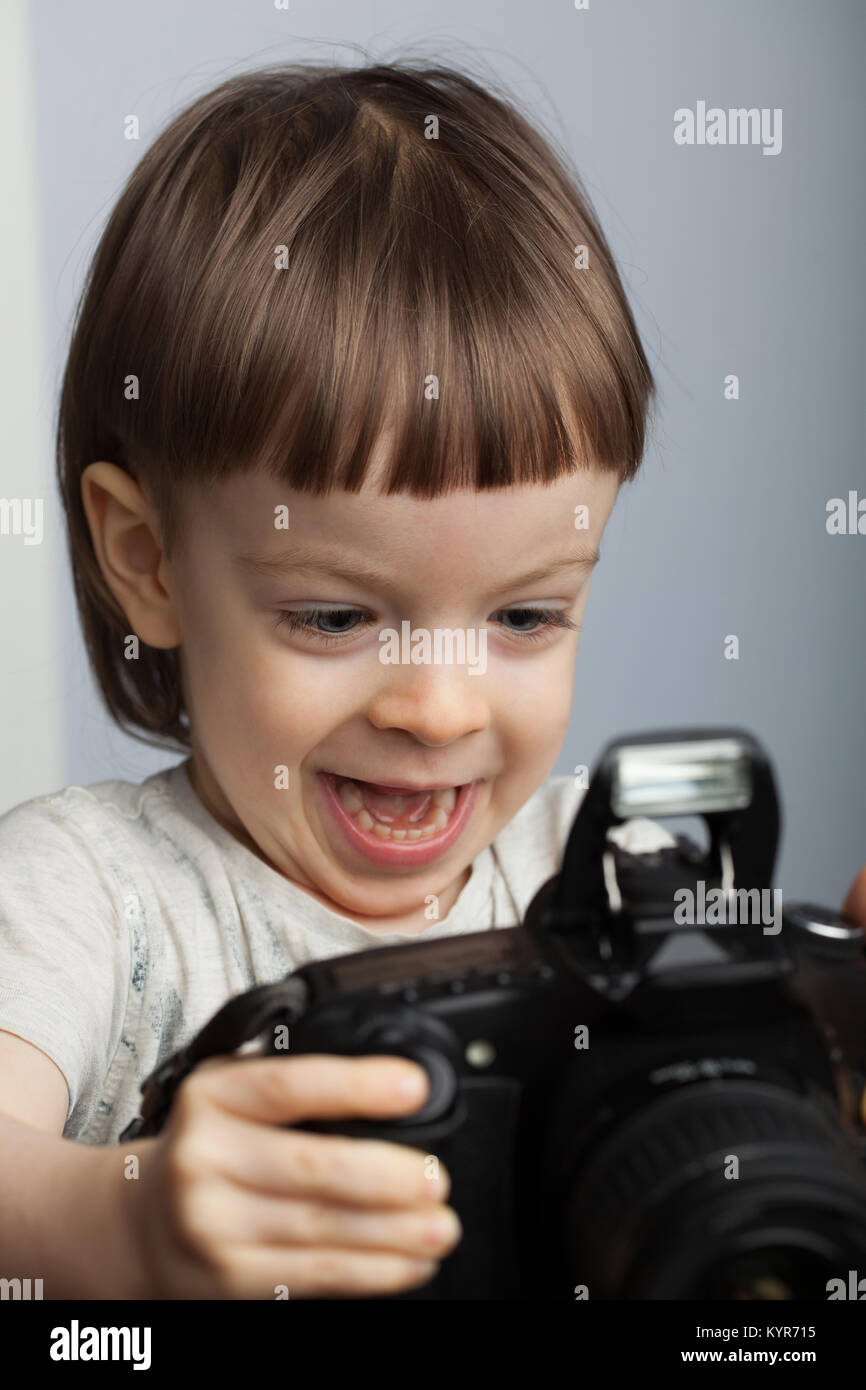 Beautiful child in with professional camera. Little boy with long blond ...