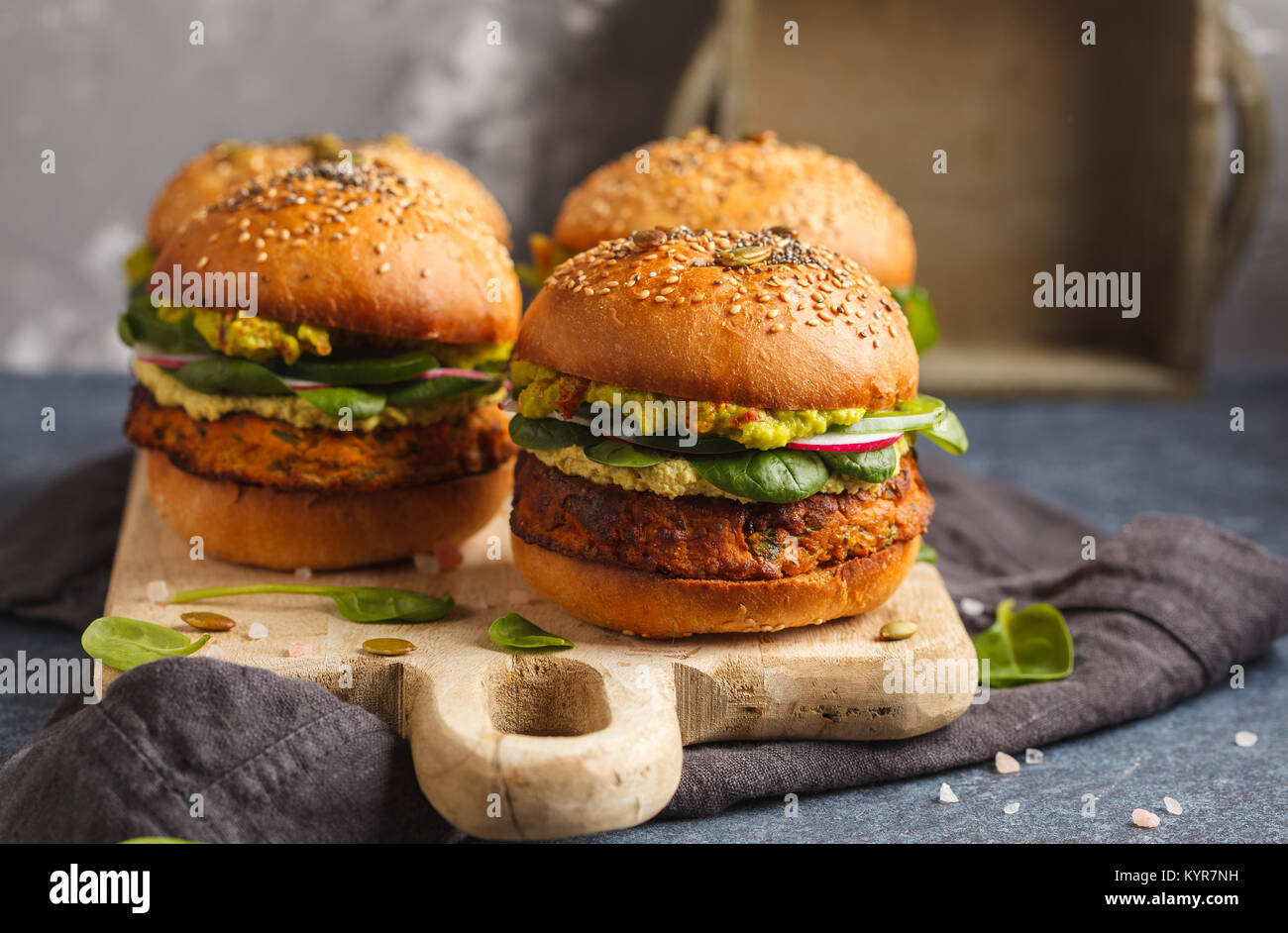 Healthy baked sweet potato burger with whole grain bun, guacamole, vegan mayonnaise and