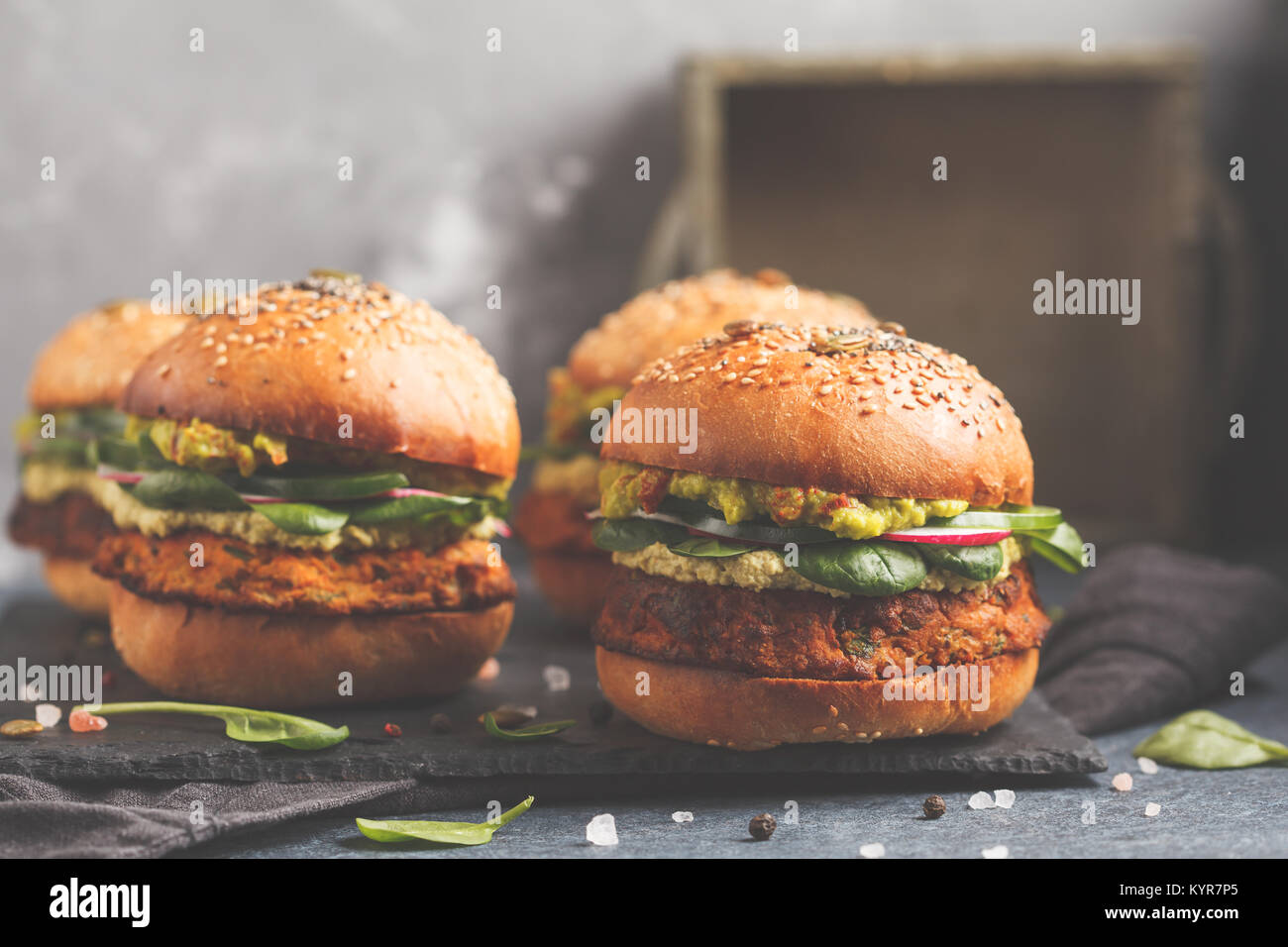 Healthy baked sweet potato burger with whole grain bun, guacamole, vegan mayonnaise and