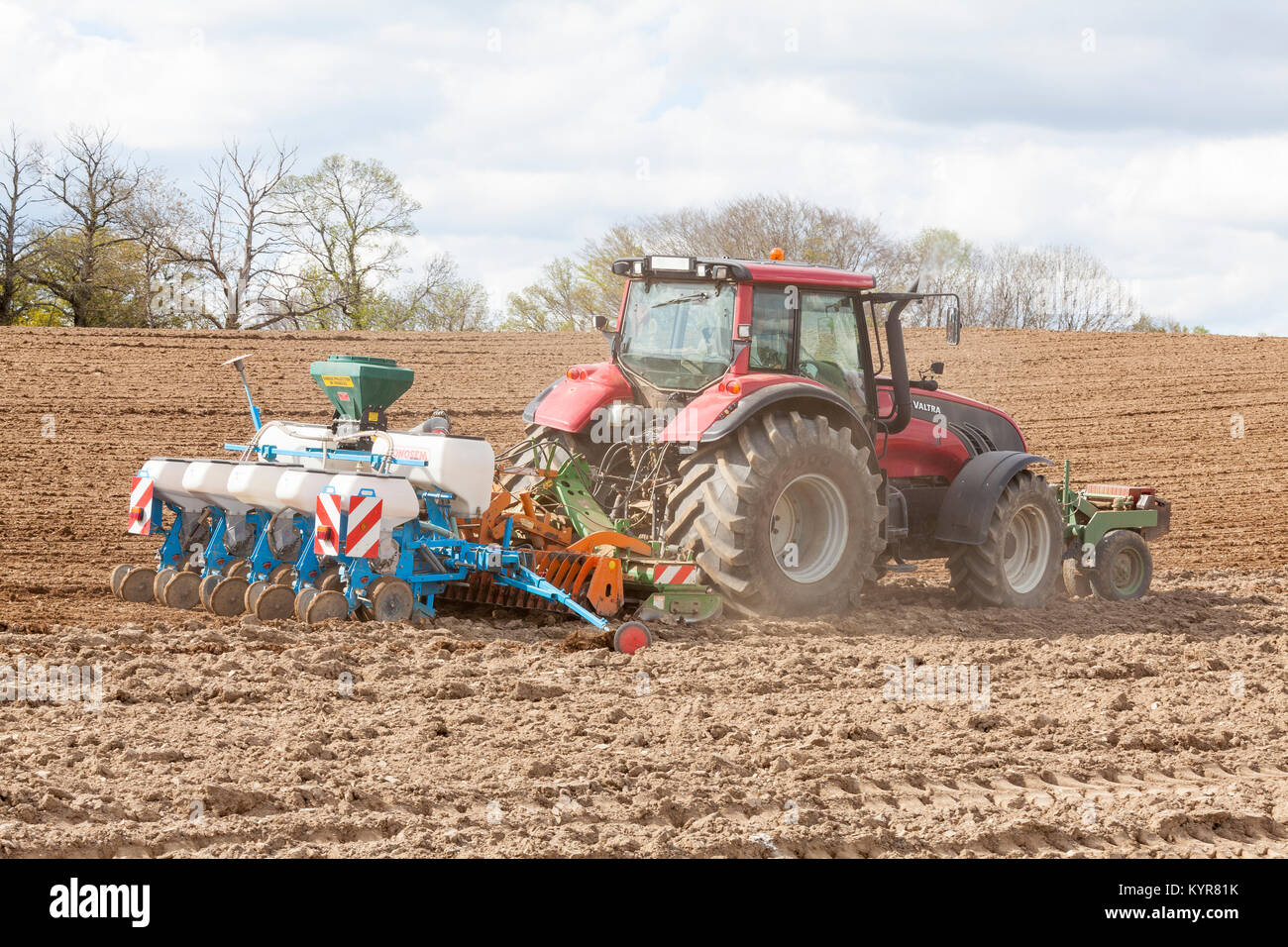 Farmer using  a Monosem NG 4 plus pneumatic planter to seed or plant the spring crop of maize,  corn, Zea mays Stock Photo