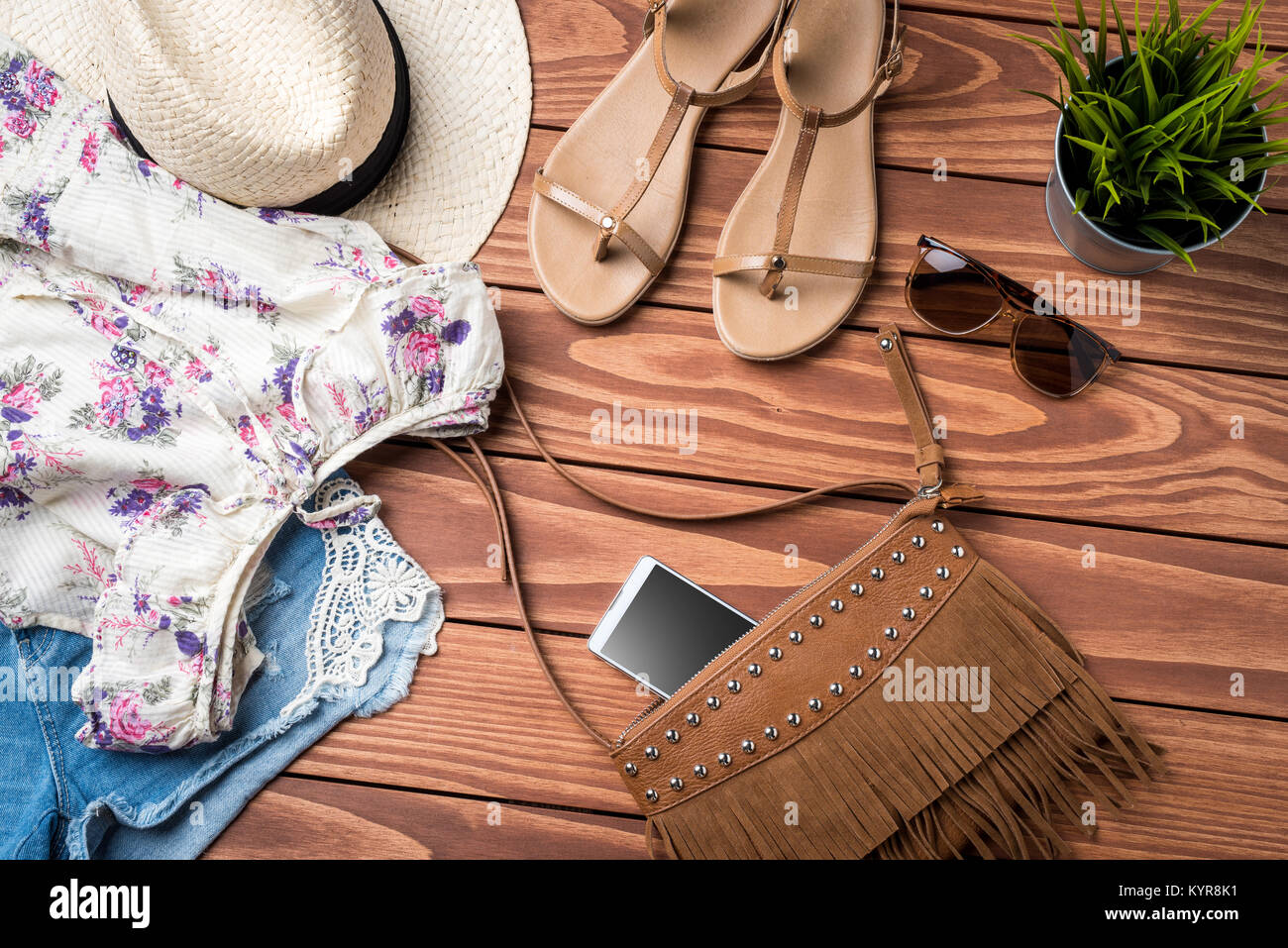 Women's summer clothes on wooden table. Fashion background Stock Photo