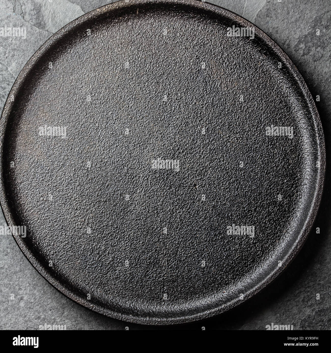 Food background. Empty cast iron black plate. Copy space Stock Photo