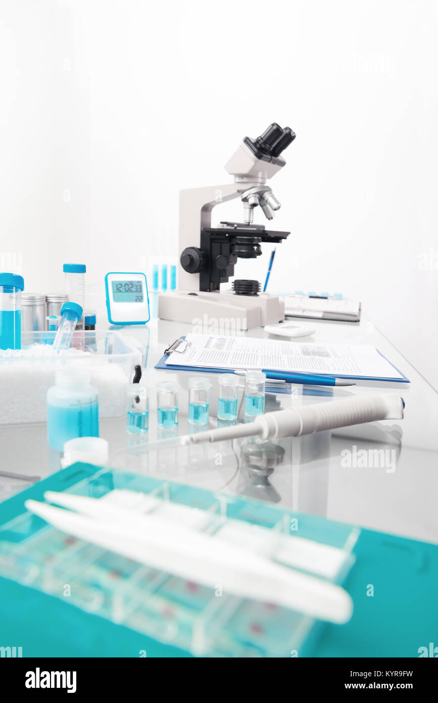 Science background with microscopic work station. Microscope and tools for histological staining for cancer diagnostics, This is blurred background wi Stock Photo