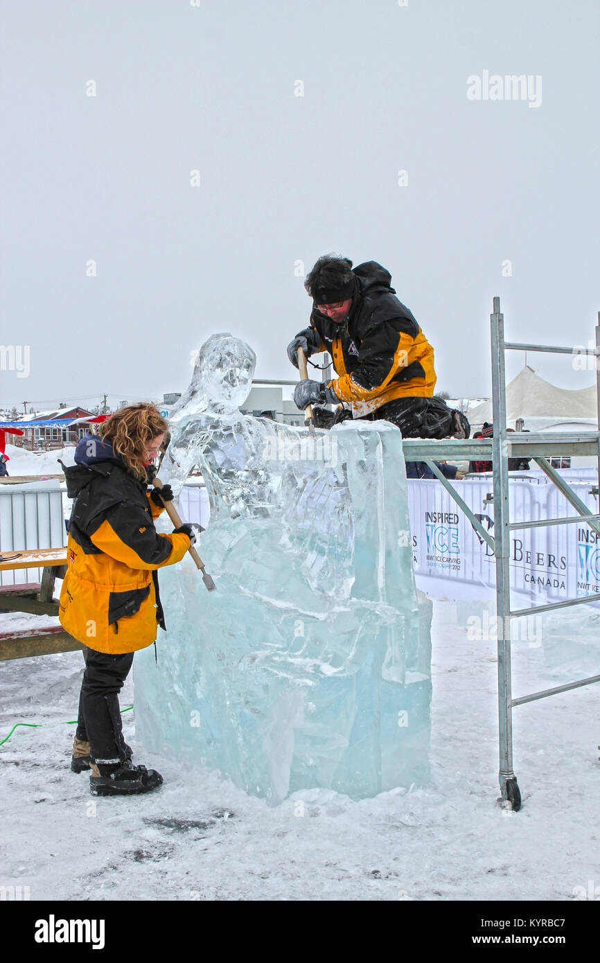 Ice carvers working at the De Beers Inspired Ice NWT Carving Championship, Long John Jamboree winter festival, Yellowknife, Northwest Territories. Stock Photo