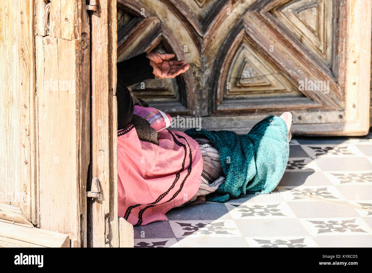 A female panhandler's hand begging for money at a church door in San Miguel de Allende,Mexico Stock Photo