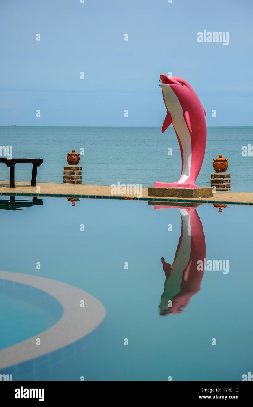 Pink dolphin statue beside swimming pool close to sea Stock Photo Alamy