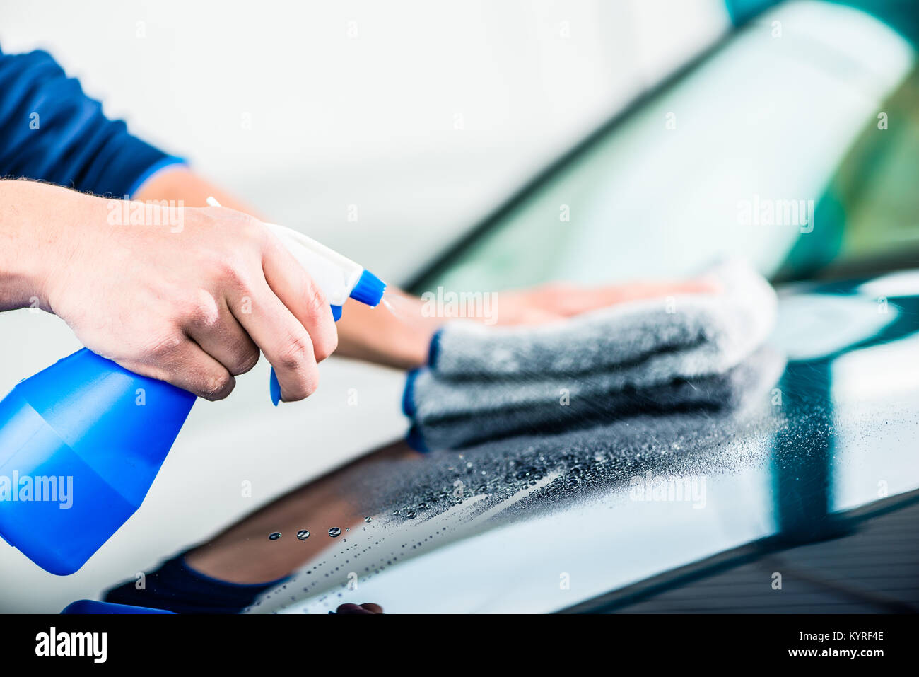 Hands cleaning car with spray cleaner and microfiber towel Stock Photo