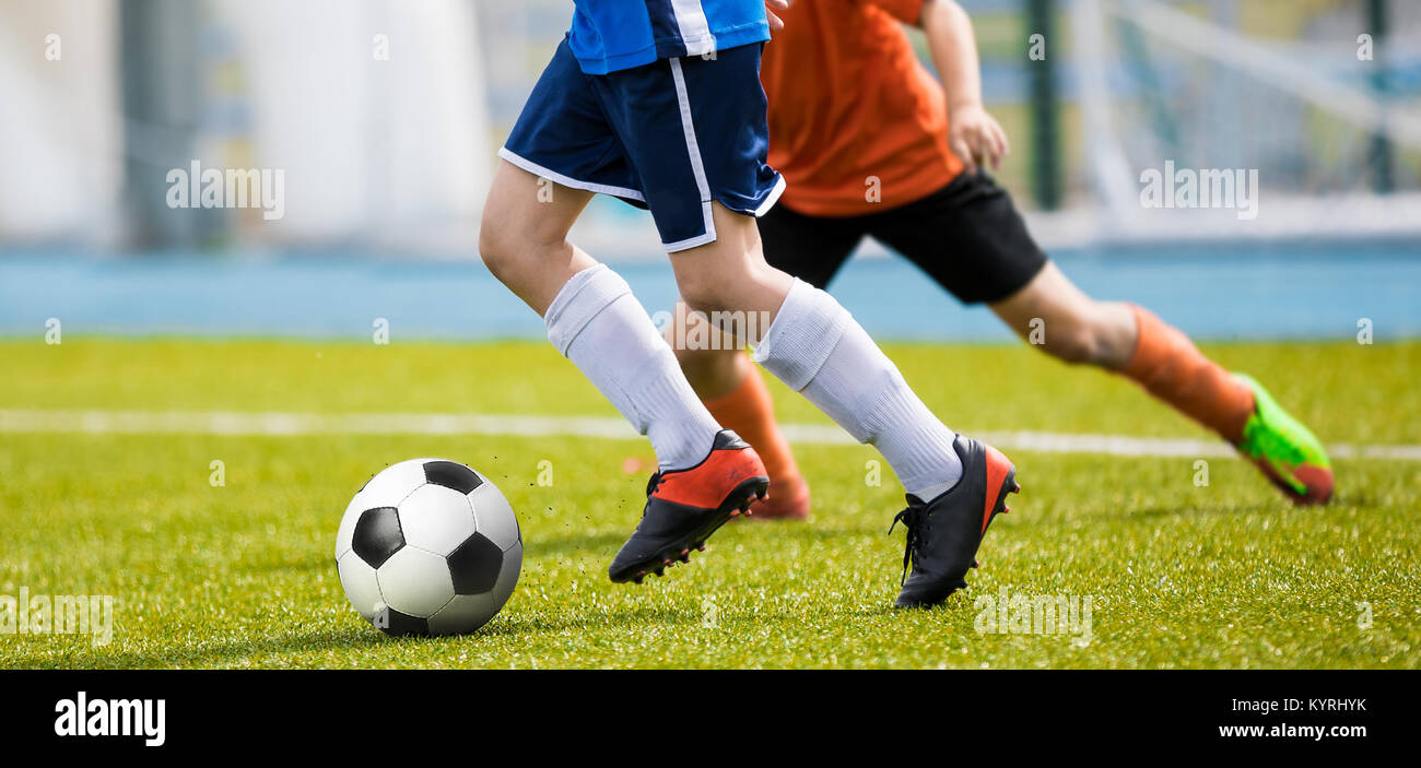 Running Training for Soccer. Soccer Players' Running Session. Youth Soccer Players Tackle and Compete on Grass Pitch Stock Photo