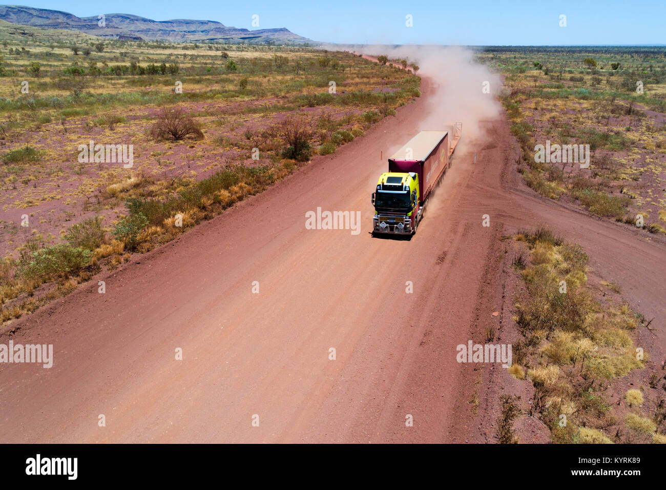 Road train truck travelling on a red dusty road in the Australian outback, Pilbara, Western Australia Stock Photo