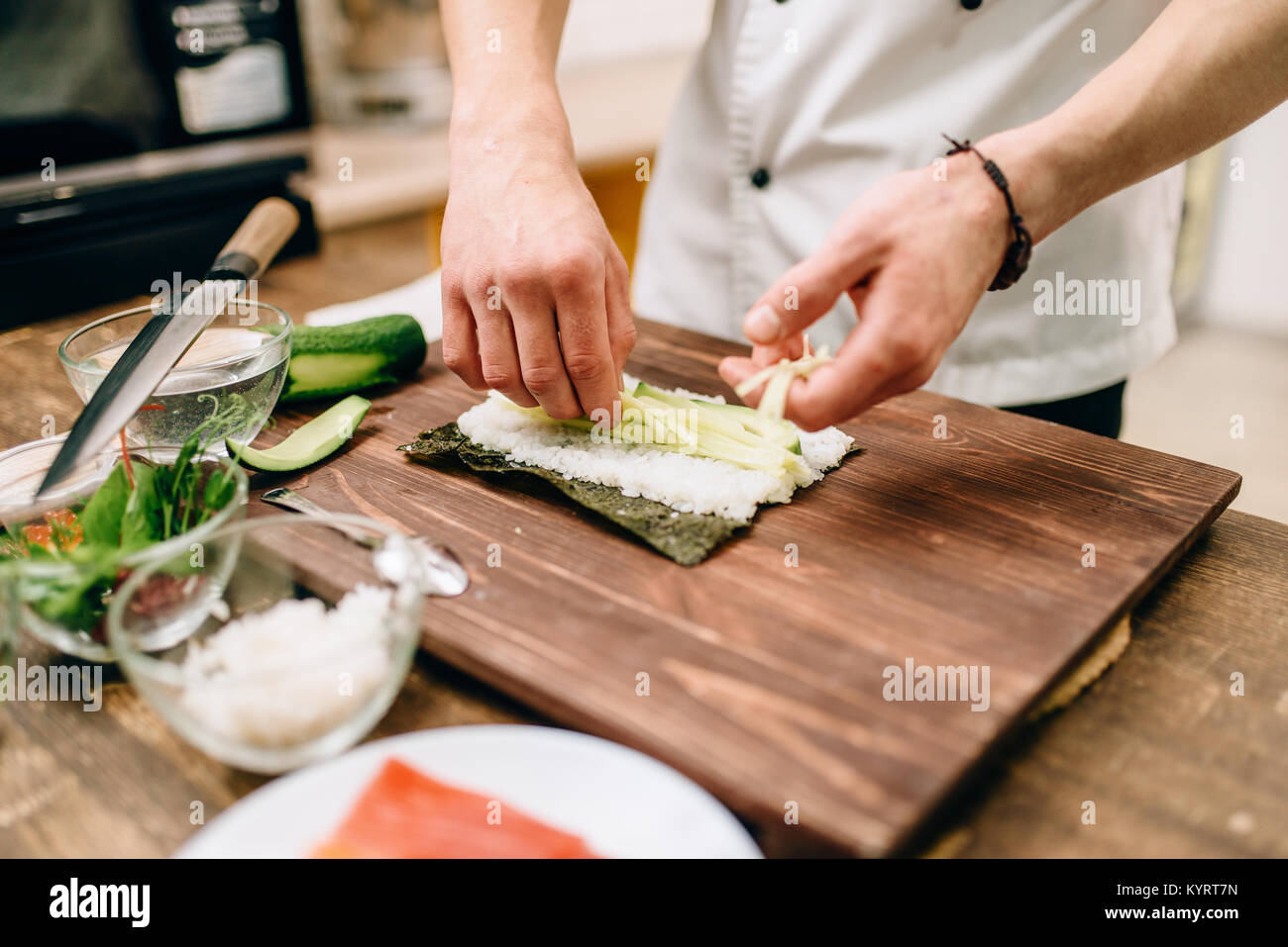 https://c8.alamy.com/comp/KYRT7N/male-cook-hands-making-sushi-rolls-seafood-traditional-japanese-cuisine-KYRT7N.jpg