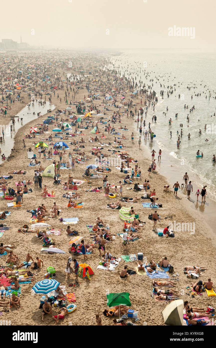 The Netherlands, Scheveningen, near The Hague or Den Haag. People sunbathing on the beach. Summertime. Aerial view from pier. Stock Photo
