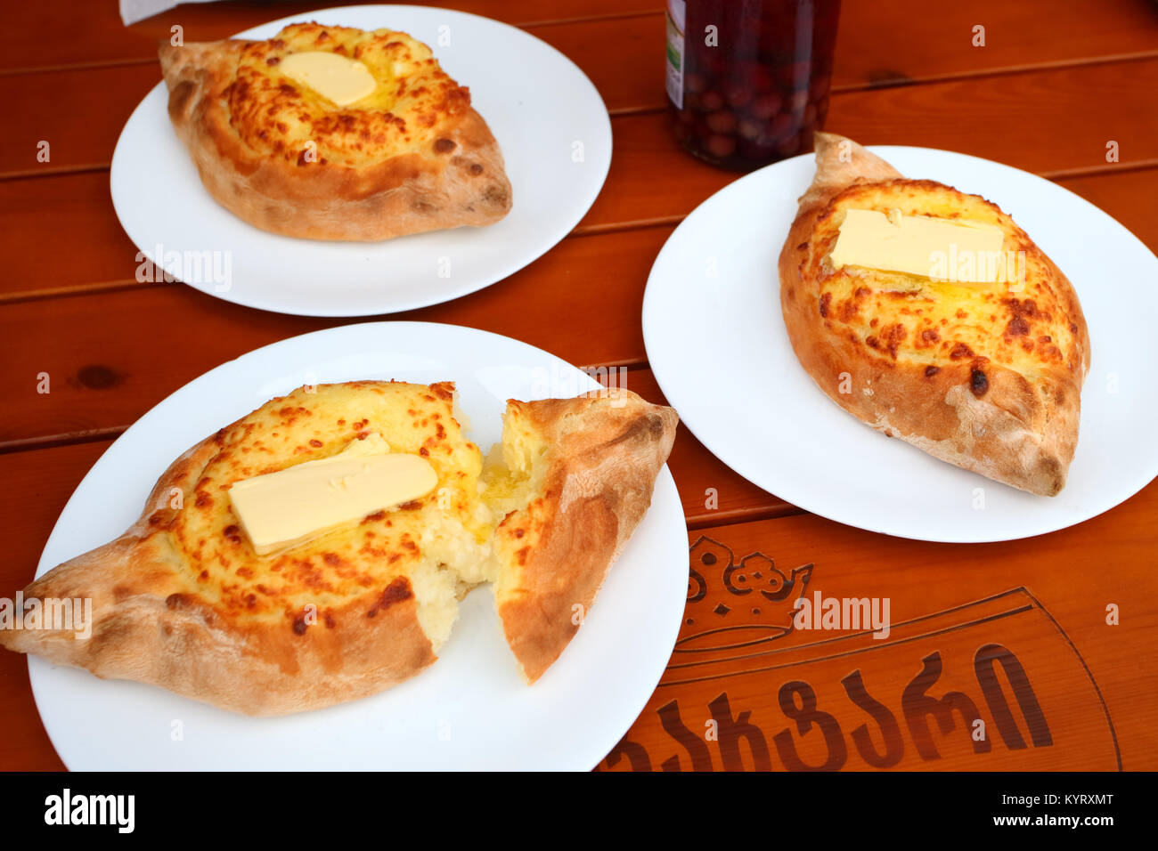 Traditional georgian cuisine: bread with cheese and egg called khachapuri Stock Photo