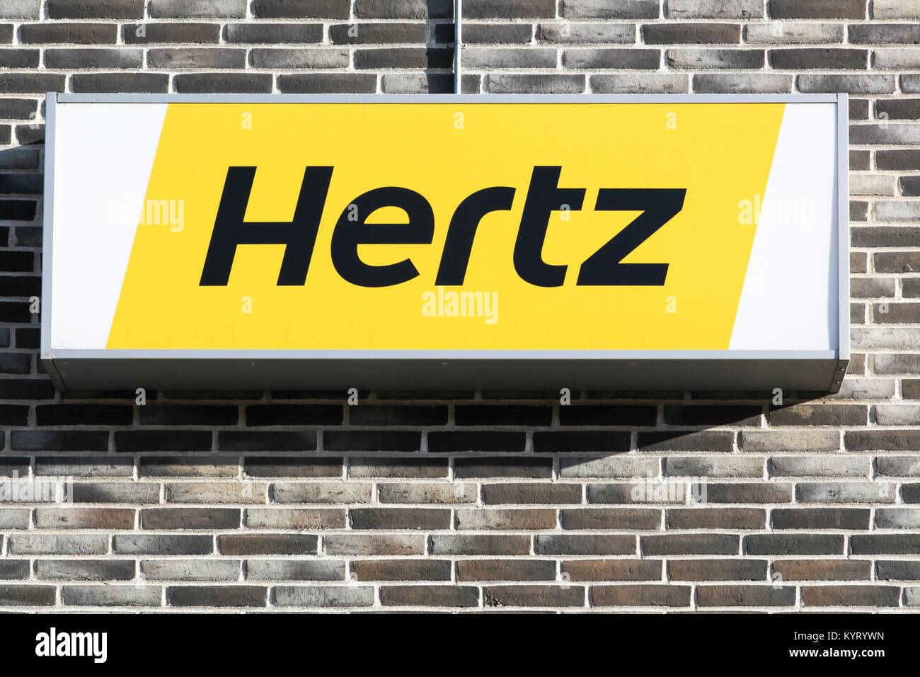 Aalborg, Denmark - July 13, 2017: Hertz logo on a panel. Hertz is an American car rental company with international locations in 145 countries Stock Photo