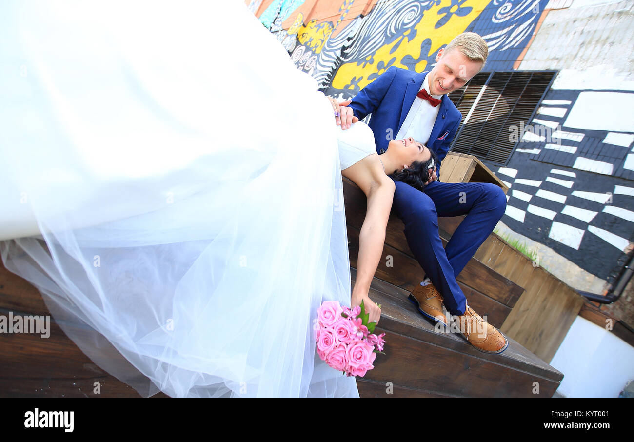 bride and groom sitting in the summer amphitheatre Stock Photo - Alamy