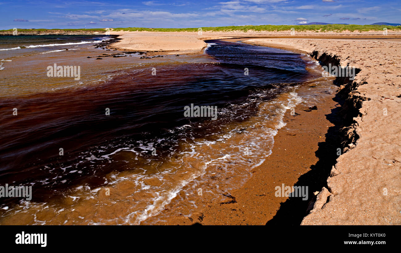 Sandy beach eroded by the outgoing tide at Dugort, Achill Island on the Irish coast Stock Photo
