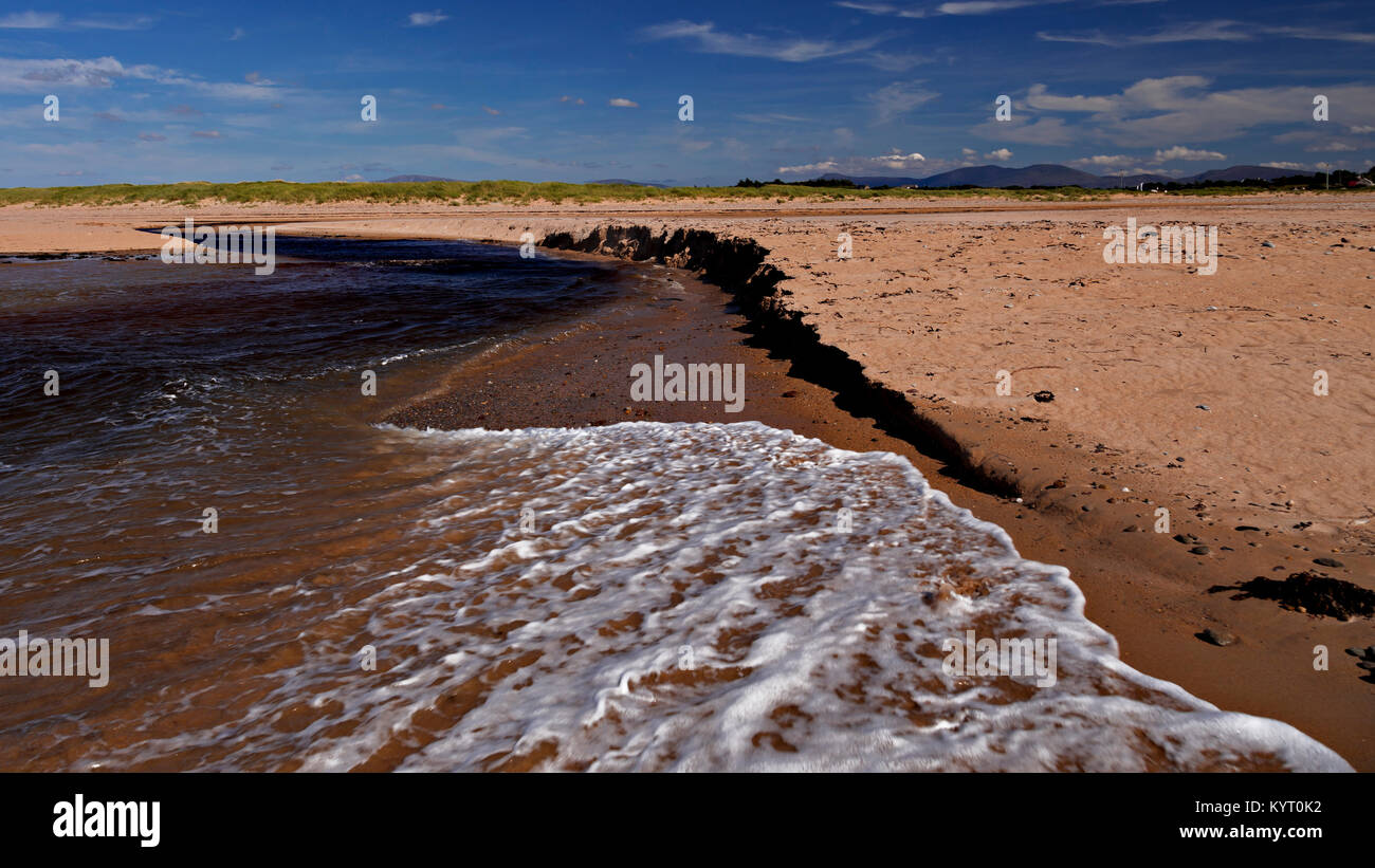 Sandy beach eroded by the outgoing tide at Dugort, Achill Island on the Irish coast Stock Photo