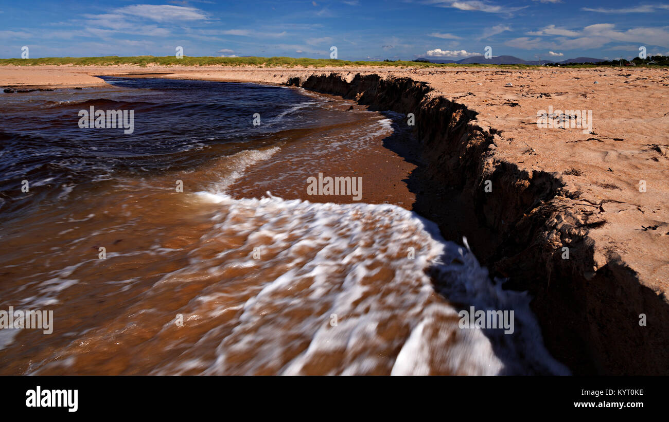 Sandy beach eroded by the outgoing tide at Dugort, Achill Island on the Irish coast Stock Photo
