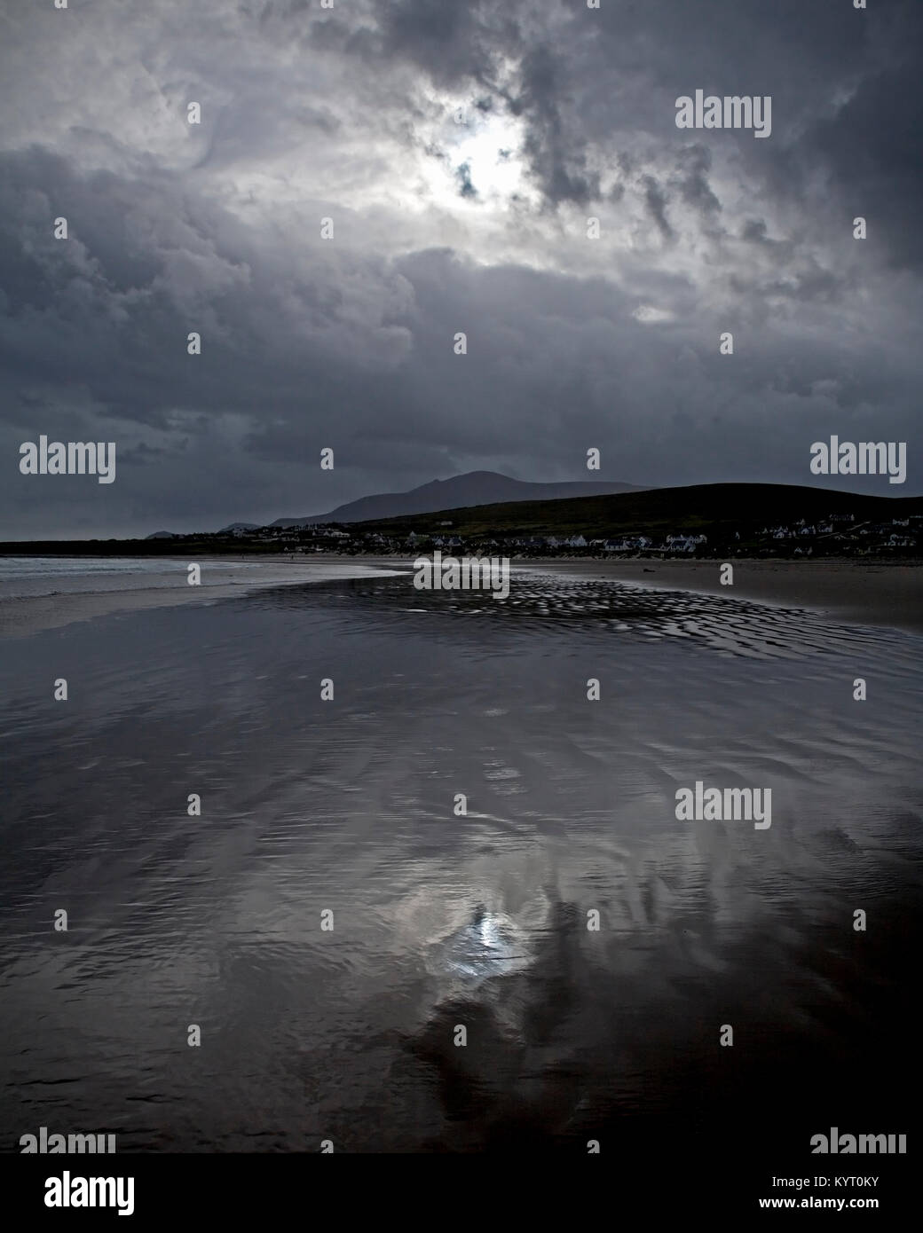 Stormy clouds reflecting in wet sand on the beach at Achill Island on the Irish coast Stock Photo