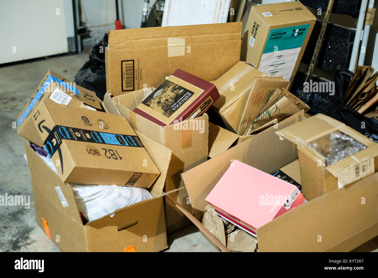 A pile of cardboard boxes in a garage saved for moving day. Oklahoma, USA. Concepts. Stock Photo