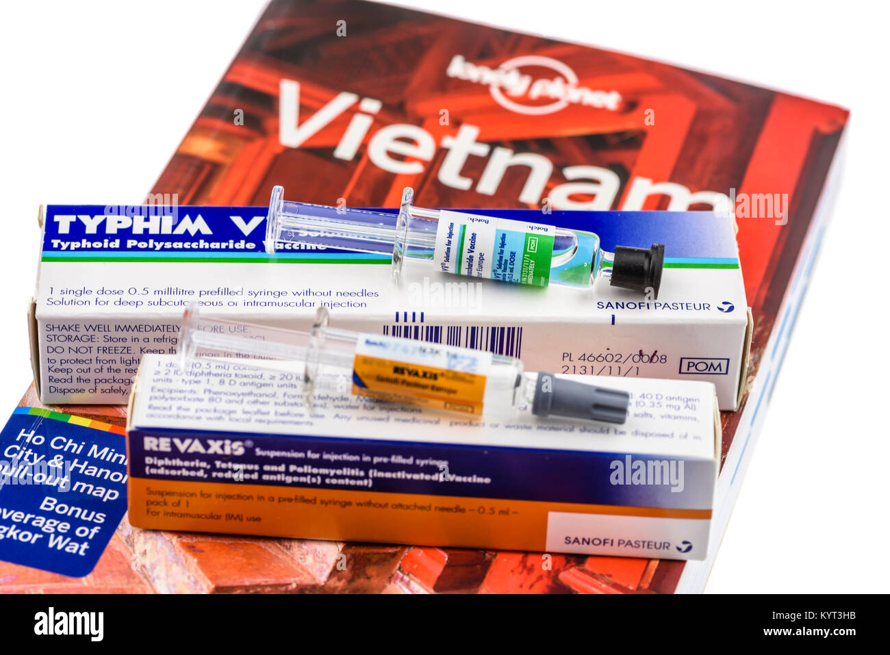 Typhim typhoid vaccine and Revaxis diptheria, tetanus and poliomelitis vaccine sitting on a Lonely Planet travel guide for Vietnam Stock Photo