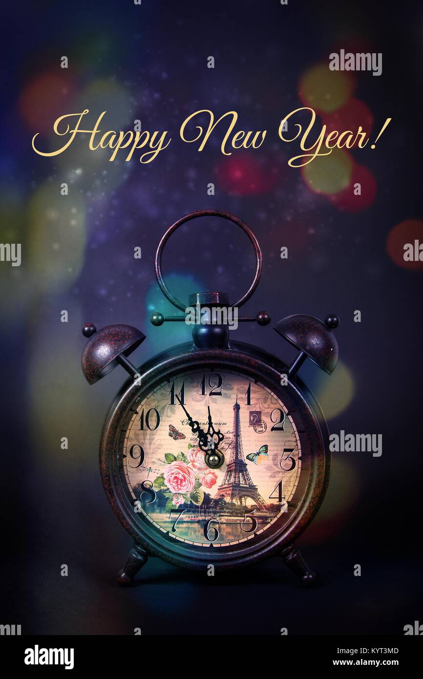 An old vintage clock with sparkles and bokeh lights on a black background  with the quote Happy New Year Stock Photo - Alamy