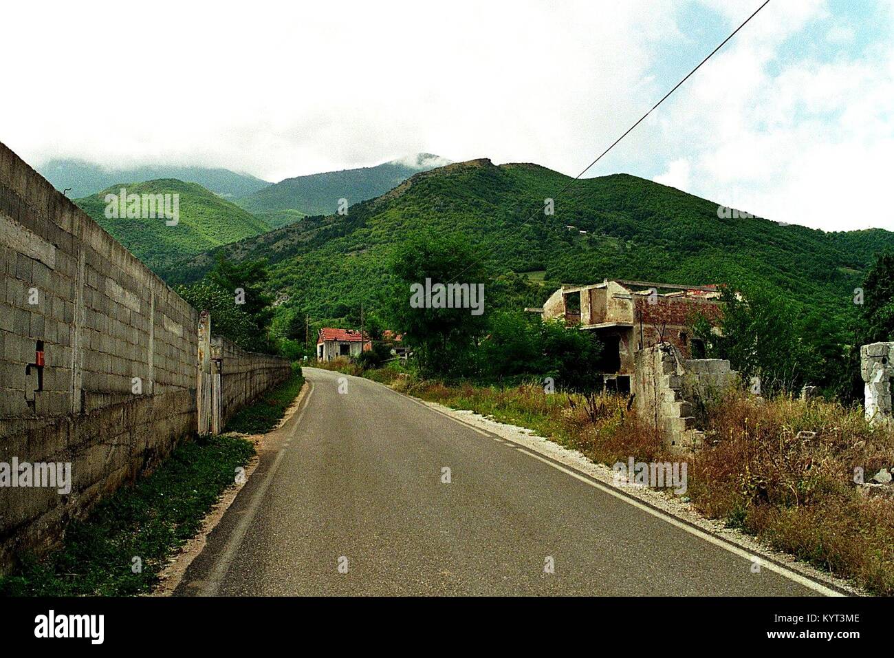 The Serbian village of Belo Polje (Bellopoja) near Peć/Peja in Kosovo was burnt down in March 2004 by Albanians. The village remained devastated, the inhabitants fled. This picture from August 2006 Shows the empty and destroyed main road through this village. Stock Photo