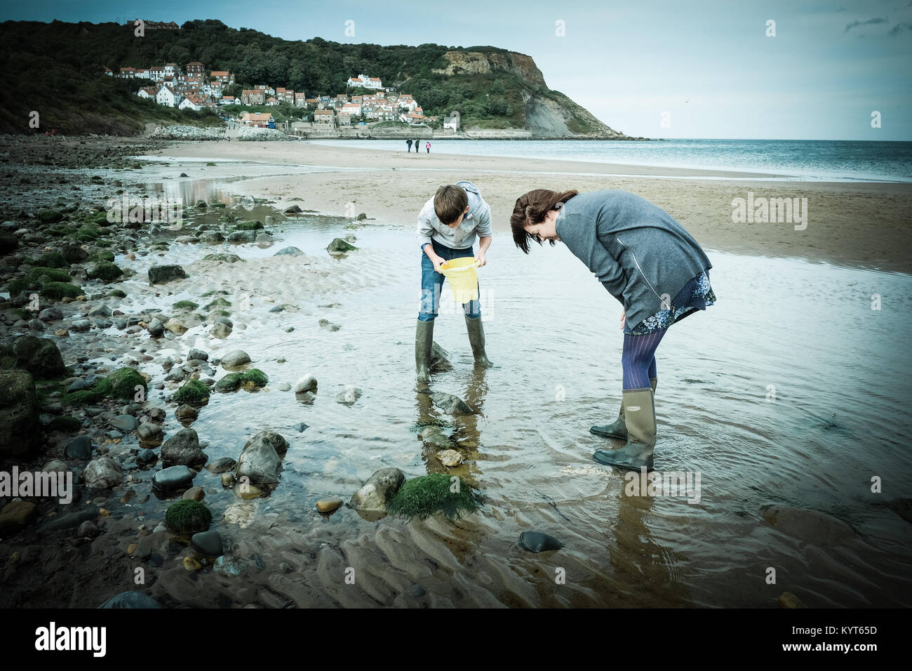 Mother and son, crabbing, fishing, rock pool, Runswick Bay, Yorkshire
