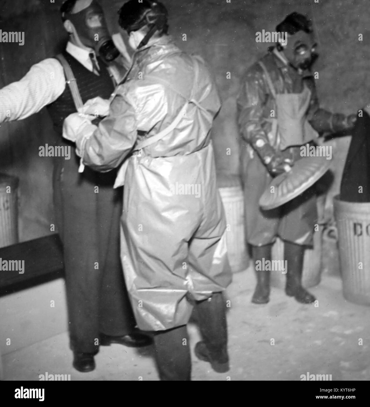 Removing clothing and burning it after a gas attack, ARP training exercise during WW2 Stock Photo