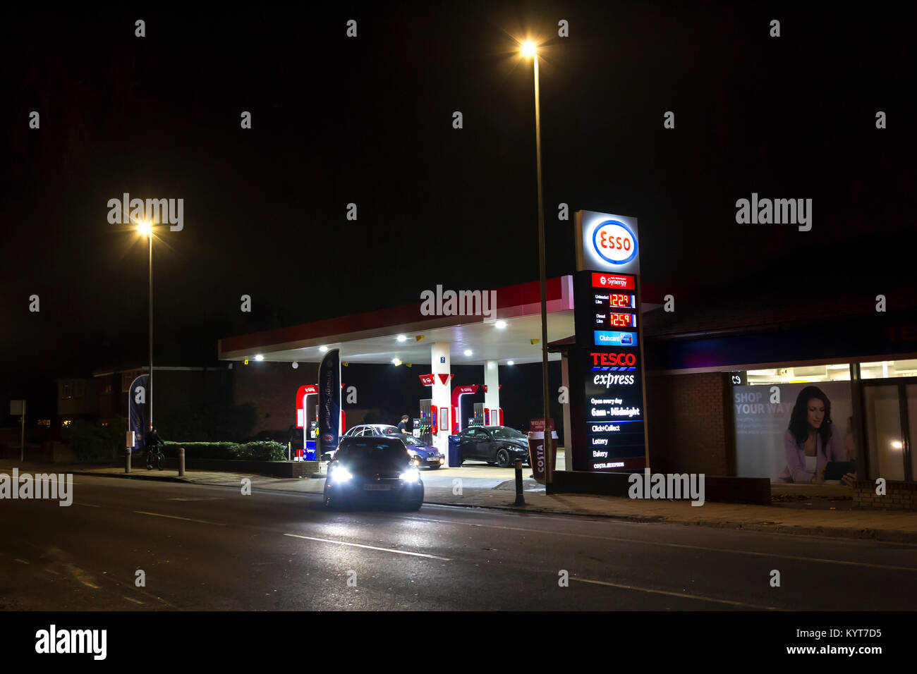 The ESSO Garage and Tesco Express on Wellingborough rd on a dark winters evening.  Northampton, Stock Photo