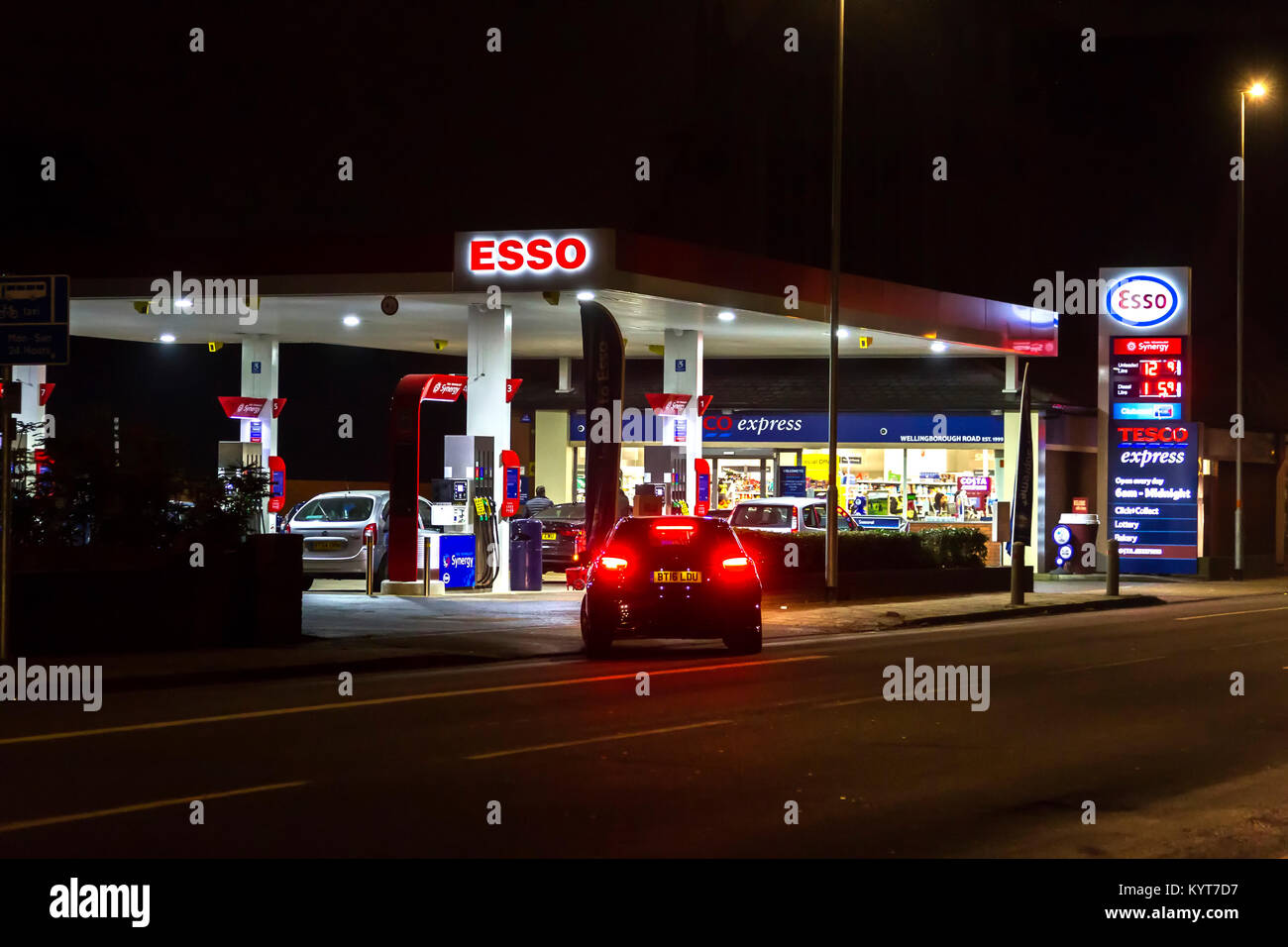 The ESSO Garage and Tesco Express on Wellingborough rd on a dark winters evening.  Northampton, Stock Photo