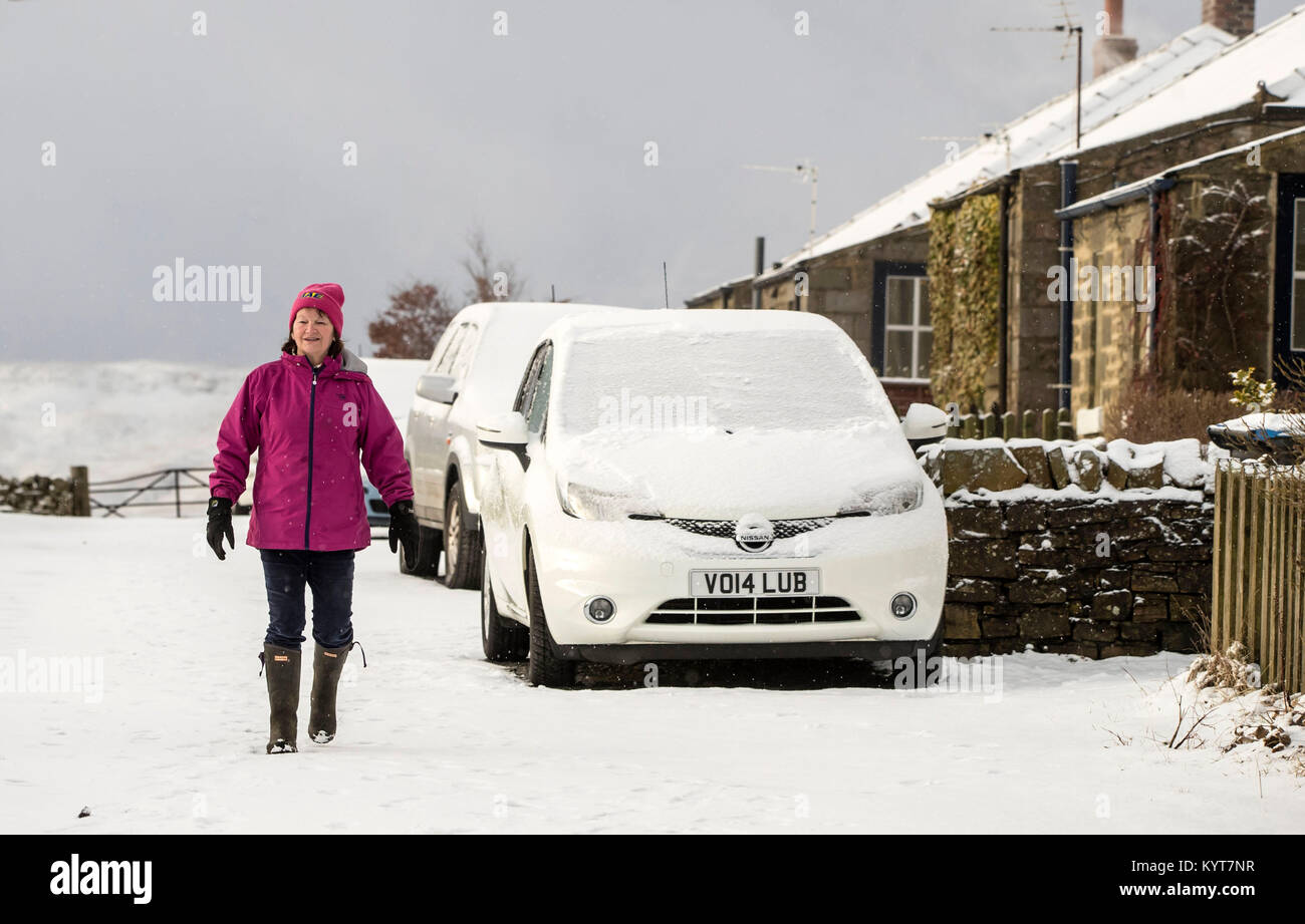 A woman in Longdon Beck as the area in the North Pennines was blanketed by snow overnight. Stock Photo