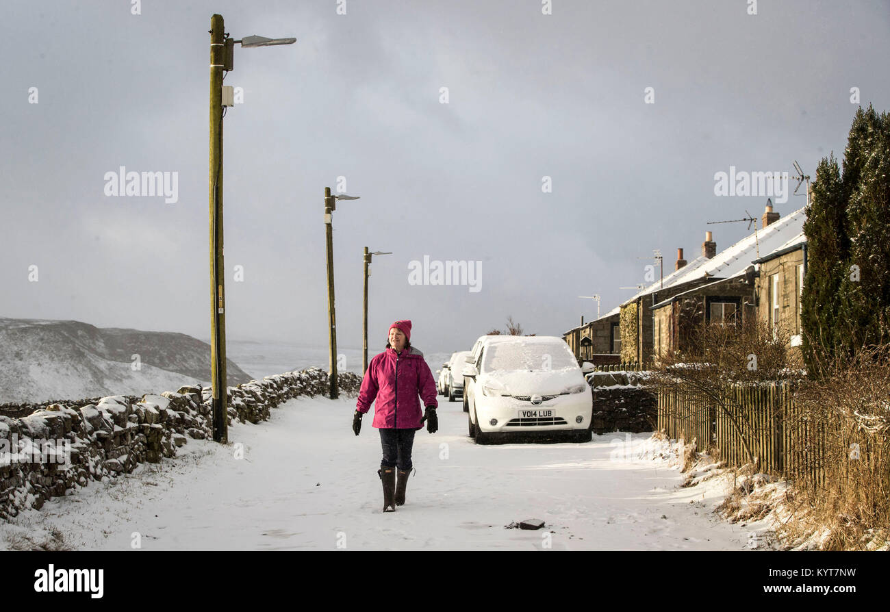 A woman in Longdon Beck as the area in the North Pennines was blanketed by snow overnight. Stock Photo