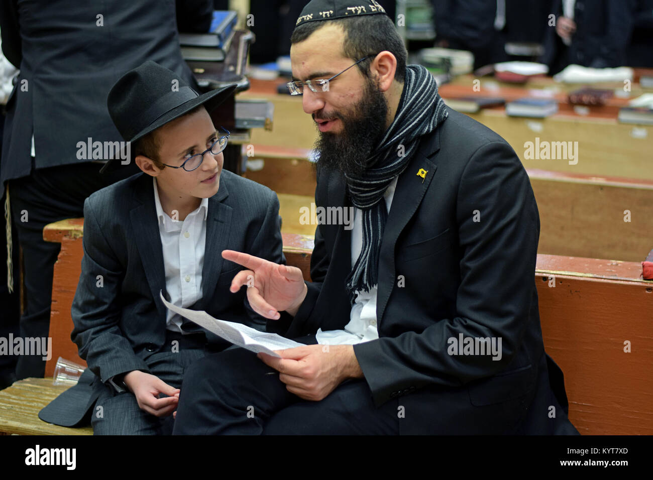 A teacher and student (presumably father & son) learning together at a synagogue in Brooklyn, New York. Stock Photo
