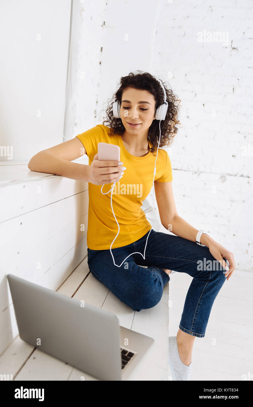 Delighted brunette girl listening to music Stock Photo