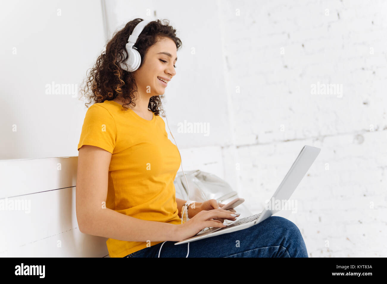 Relaxed girl having online conversation Stock Photo