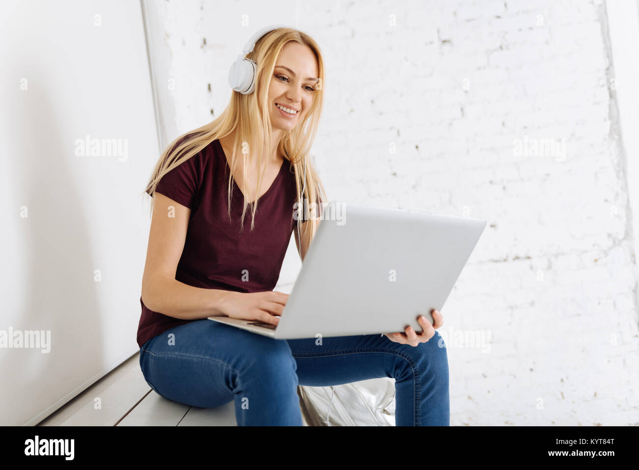 Delighted blonde having online conversation Stock Photo