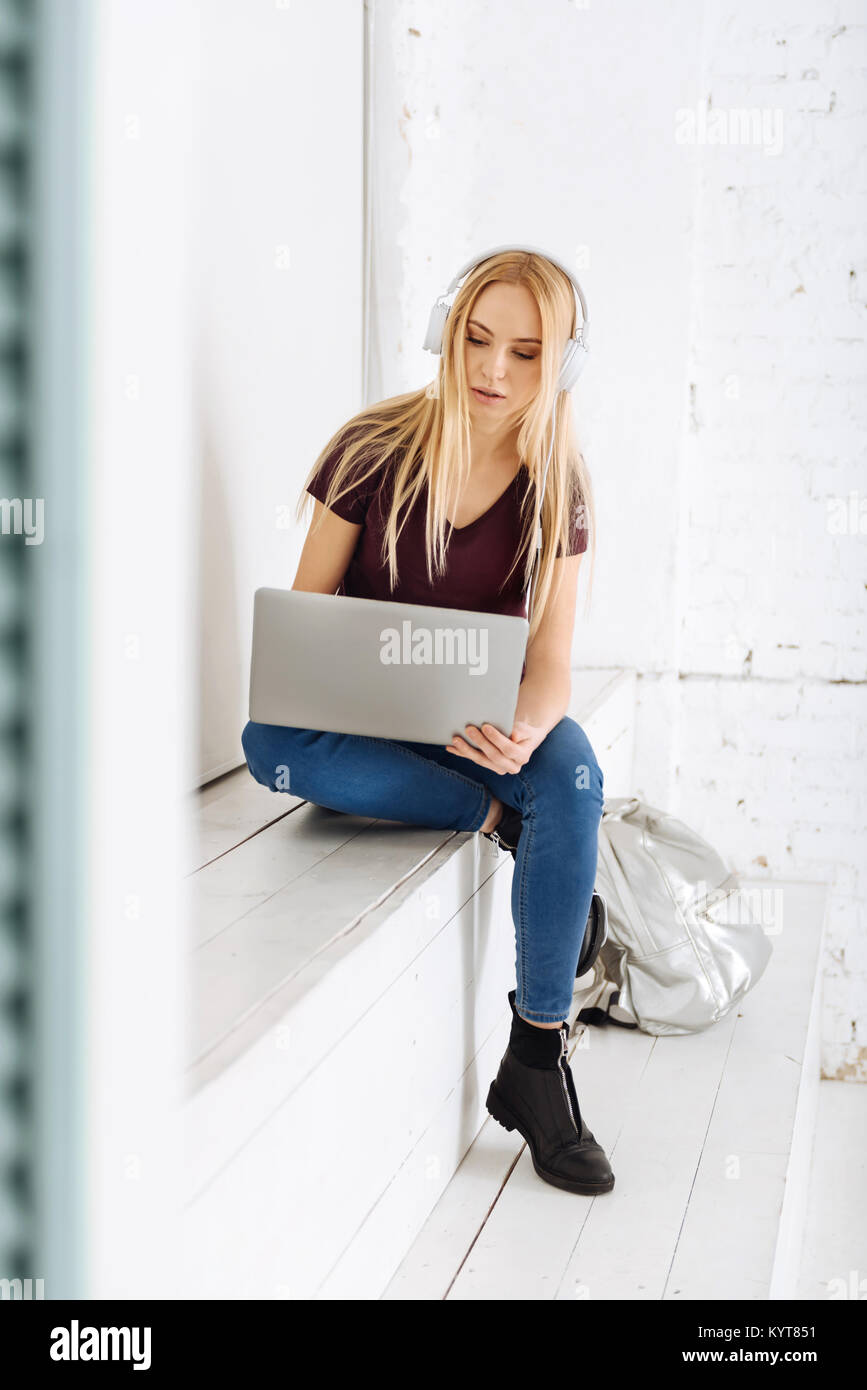 Concentrated female person using her computer Stock Photo