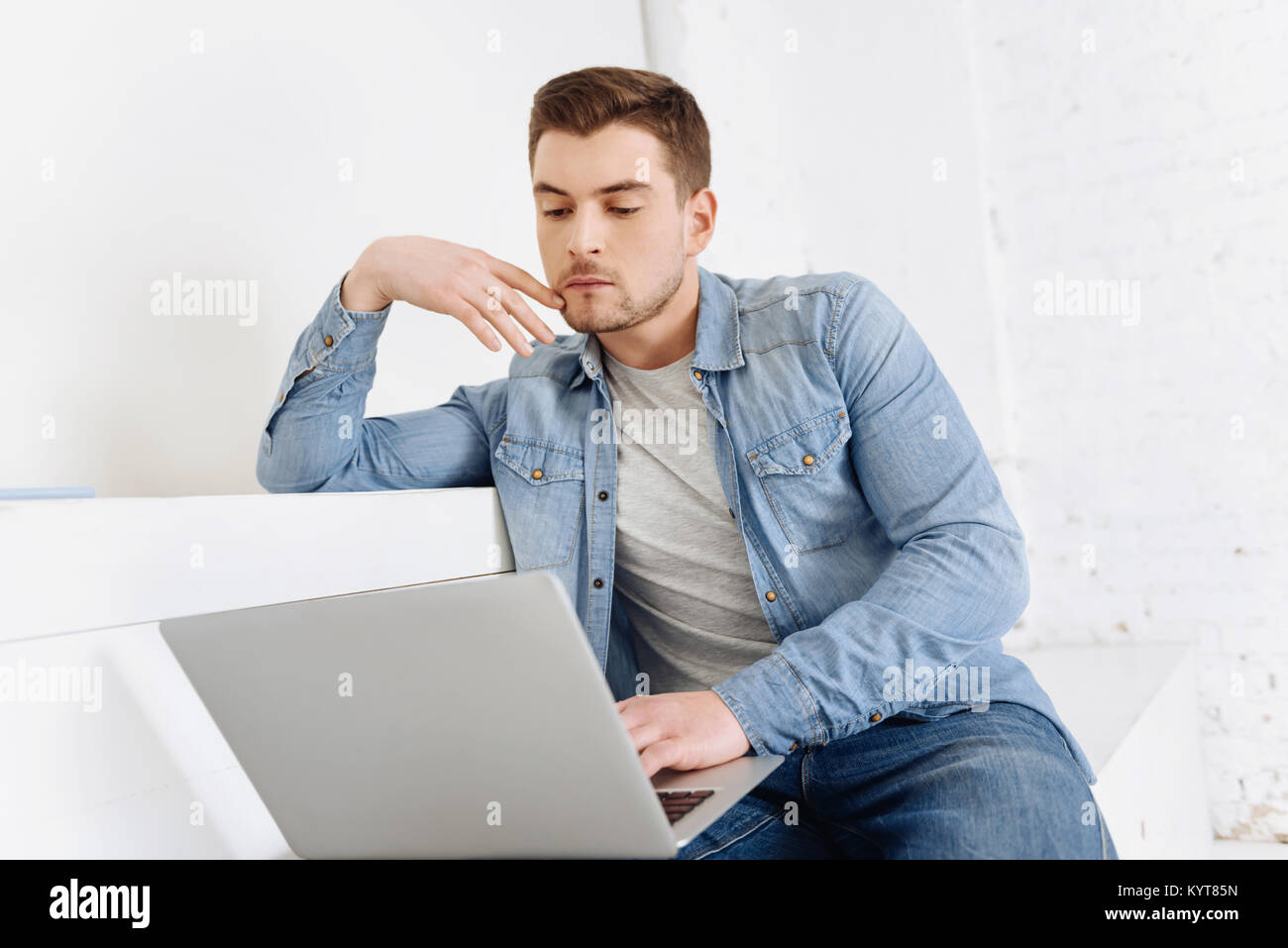 Serious young man being deep in thoughts Stock Photo Alamy