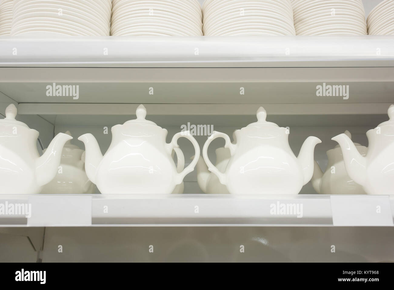 white ceramic teapots stand in the supermarket's supermarket Stock