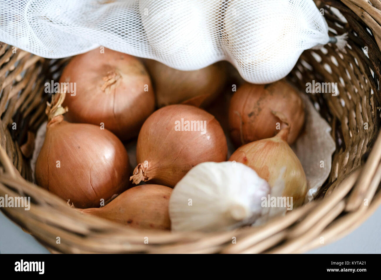 Onions and garlic in a basket Stock Photo Alamy