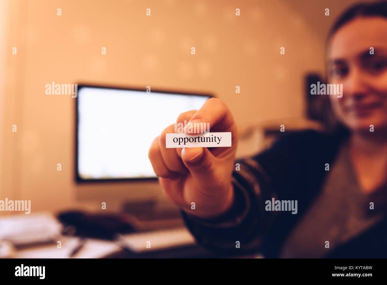 Close up of hand holding western script sign reading opportunity in ...